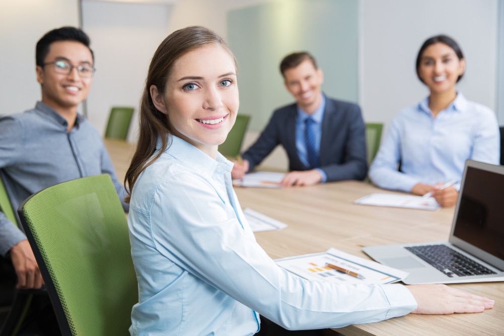smiling young businesswoman sitting boardroom